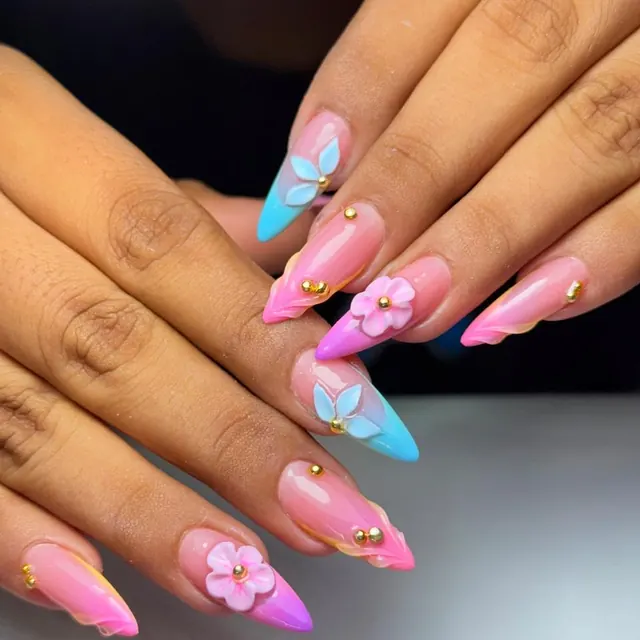 A pastel set with freehand nail art across several fingers.
